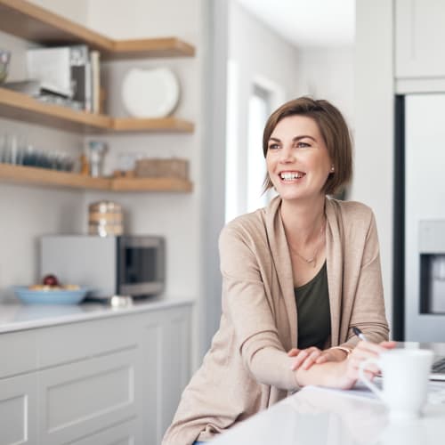 A resident having her coffee in kitchen at Ben Moreell in Norfolk, Virginia