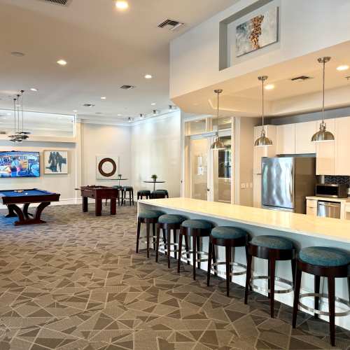 Stainless-steel refrigerator appliances and white cabinets at {location_name}} in Plantation, Florida