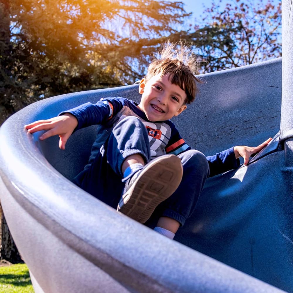 Child on the playground at The Gates in Houston, Texas