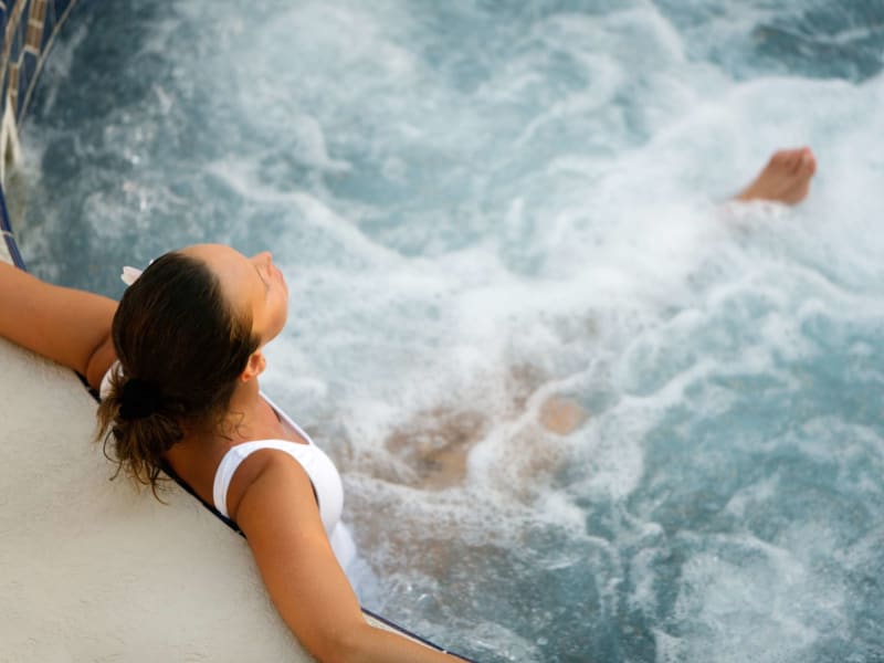 Resident relaxes and refreshes in the spa at Quintana at Cooley Station in Gilbert, Arizona