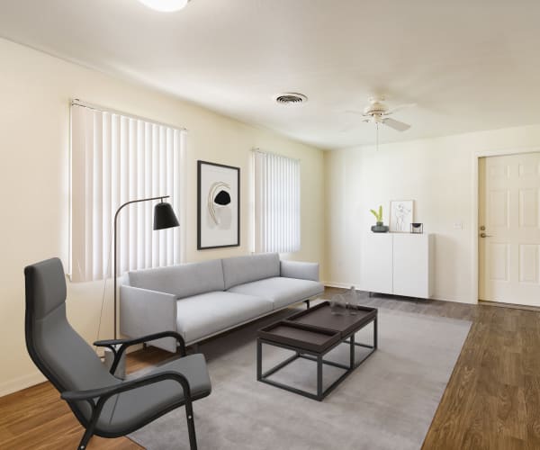 A living space with bright windows in a home at Kiskiak Village in Newport News, Virginia