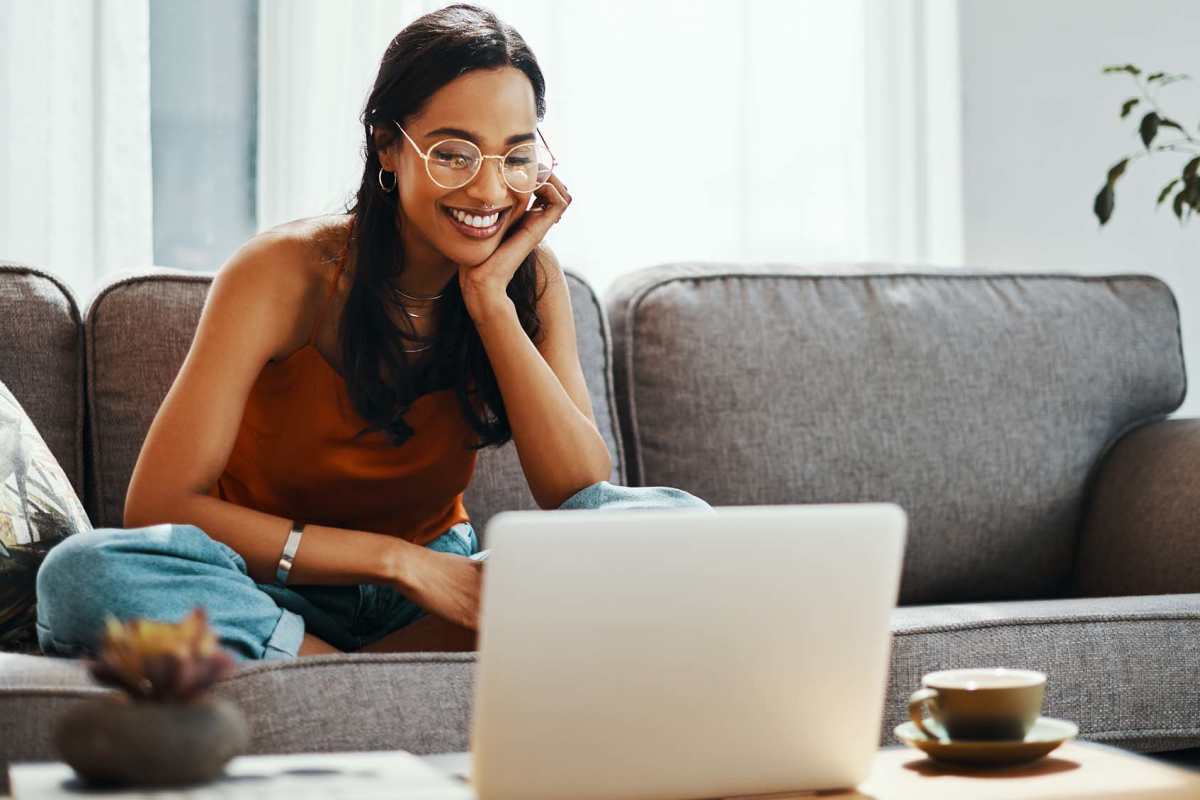 Resident looking at laptop at Oakcreek Apartments in Conroe, Texas