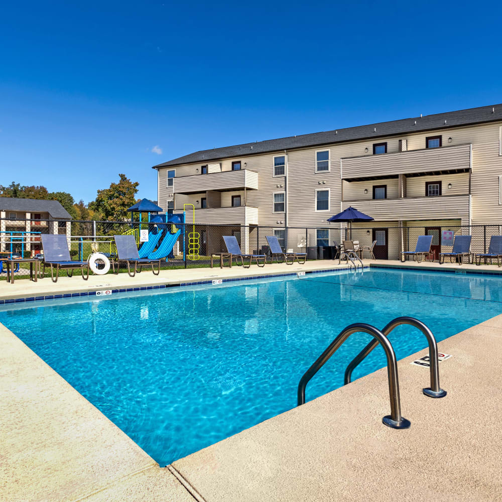 Swimming pool surrounded by lounge chairs at Alexander Station Apartment Homes in Salisbury, North Carolina