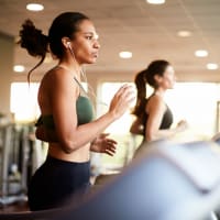 Two women running on treadmills in the fitness center at Retreat at the Park in Burlington, North Carolina