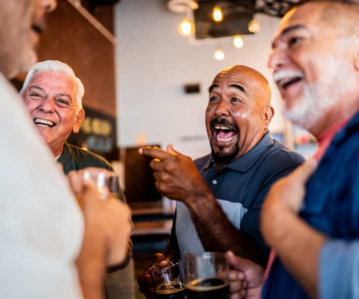 Resident enjoying drinks in bar near Amelia Apartments in Fayetteville, North Carolina