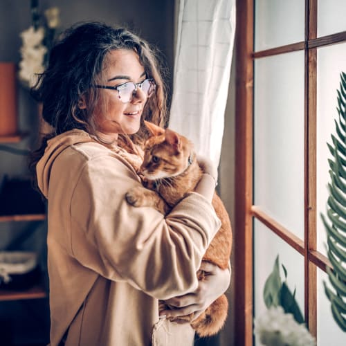 A resident holding her cat at Joshua Heights in Twentynine Palms, California