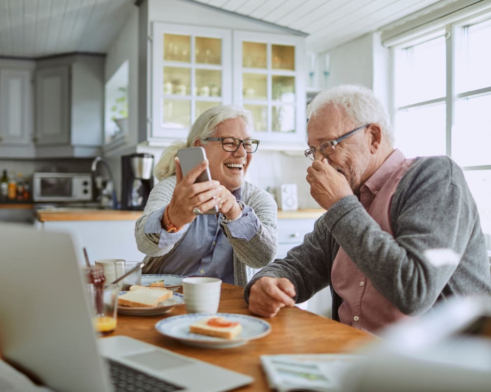 Residents laughing together during breakfast at Anthology of Millis in Millis, Massachusetts