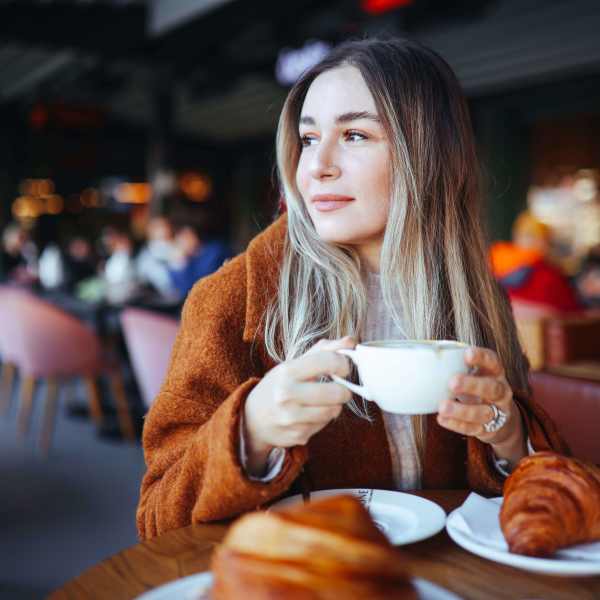 A resident enjoys coffee and pastries near Attain Downtown, Norfolk, Virginia