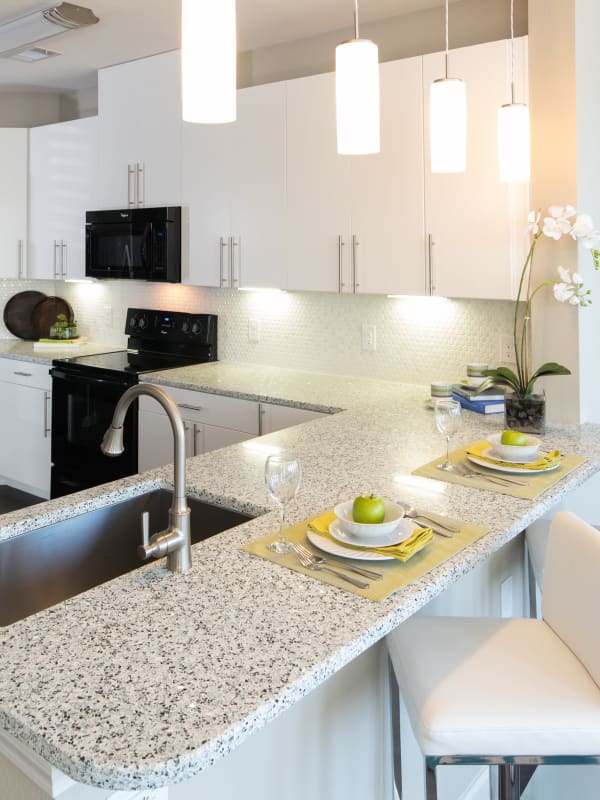 Bar seating in a modern apartment kitchen at Hebron 121 Station in Lewisville, Texas