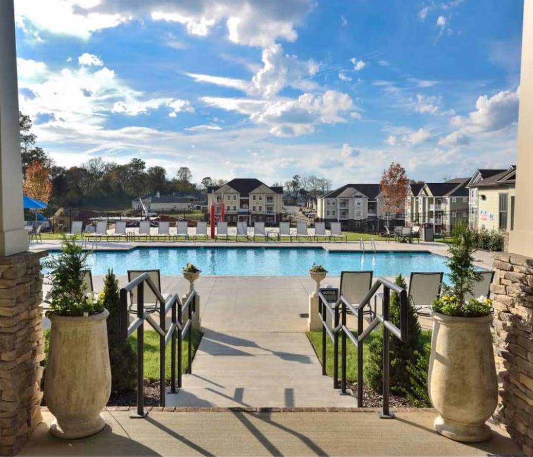 Beautifully maintained landscaping along the walkway leading to the swimming pool area at The Retreat at Arden Village Apartments in Columbia, Tennessee