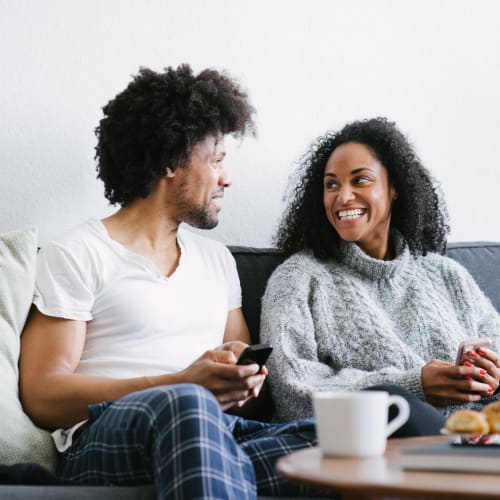 A happy couple setting on couch at Sampson Road in Dahlgren, Virginia