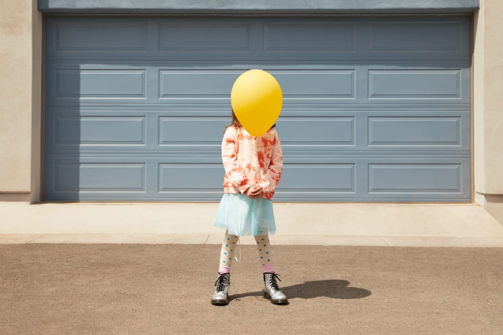 A child holding a balloon at BB Living at Union Park in Phoenix, Arizona