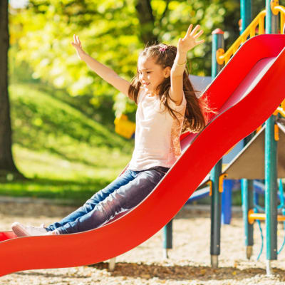 A child playing on a playground at Evergreen in Joint Base Lewis-McChord, Washington