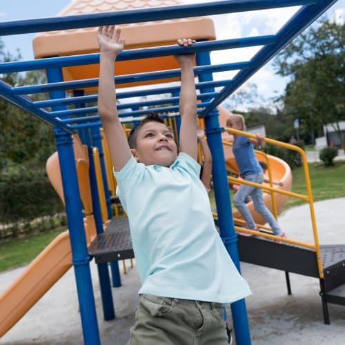 A child playing at a playground at Castle Acres in Norfolk, Virginia