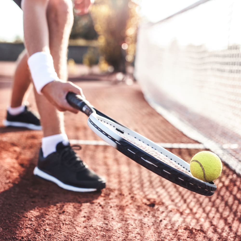 Resident playing tennis at Retreat at Waterside in Greenville, South Carolina