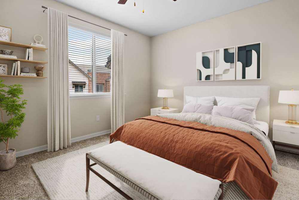 Spacious bedroom with abundant natural light from large window in an apartment at The Parc at Greenwood Village in Greenwood Village, Colorado