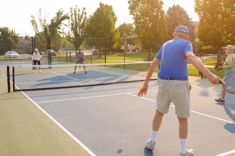 Residence enjoying a game of pickleball at Touchmark at Meadow Lake Village in Meridian, Idaho
