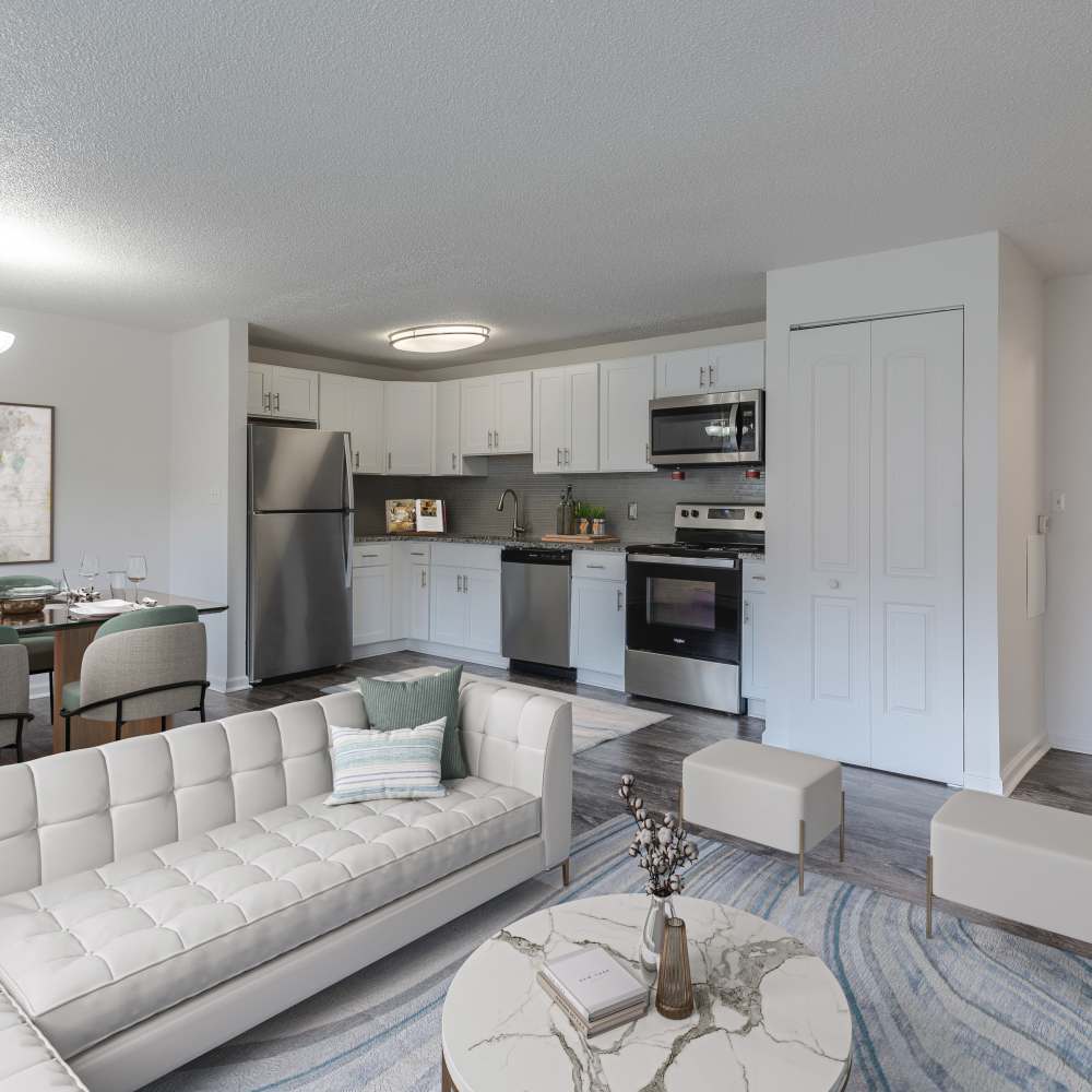 Kitchen with modern white cabinets and stainless steel appliances in a home at Creek Hill Apartments in Webster, New York