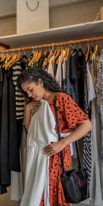 Resident woman shopping for clothes in a boutique near Magnolia Crossing and Bell Ridge II in Pace, Florida