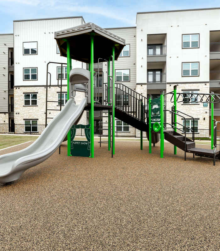 Kid playing in playground at Walnut Springs in Seguin, Texas