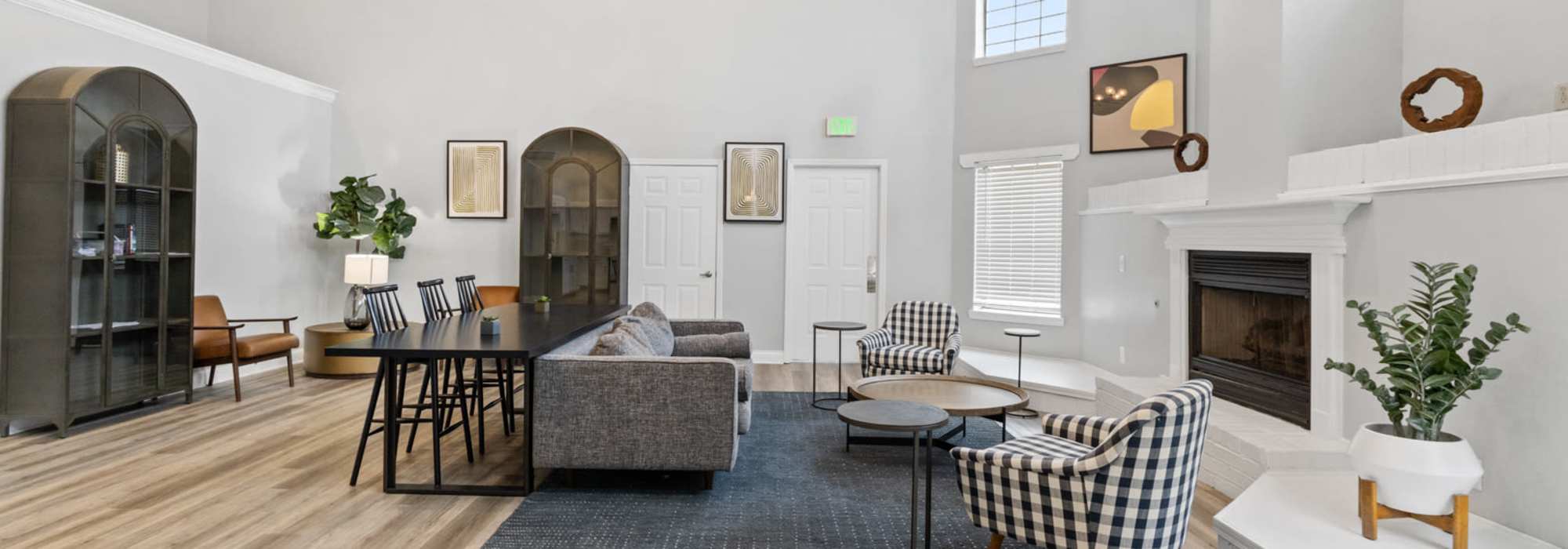 Community common area with a couch, armchairs, and a fireplace at Eagle's Edge in Indianapolis 