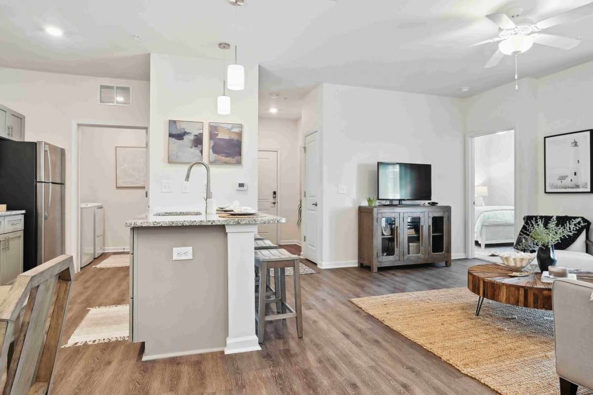 View of open kitchen and living room at Beaumont Oaks At Porters Neck Apartments & Townhomes in Wilmington, North Carolina