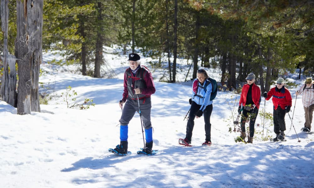 Residents snowshoeing on outing Touchmark at Pilot Butte in Bend, Oregon