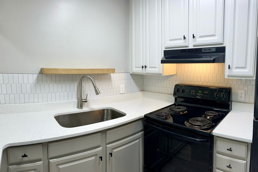 Kitchen with black appliances at Belmont Place Apartments in Nashville, Tennessee