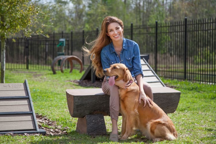 Dog and woman outside at The Gate Apartments in Champions Gate, Florida