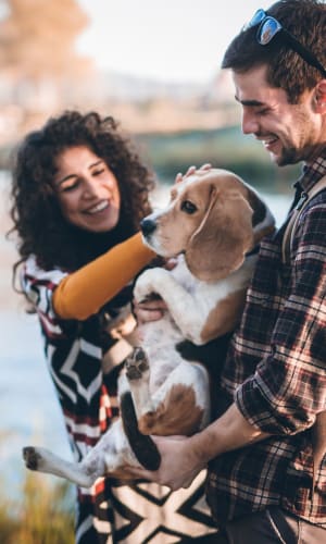 Resident couple on a walk with their beagle near Parkway Villas in Grand Prairie, Texas