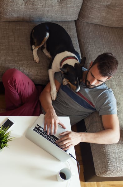 Resident working from home with some help from his puppy at EDGE on the Beltline in Atlanta, Georgia
