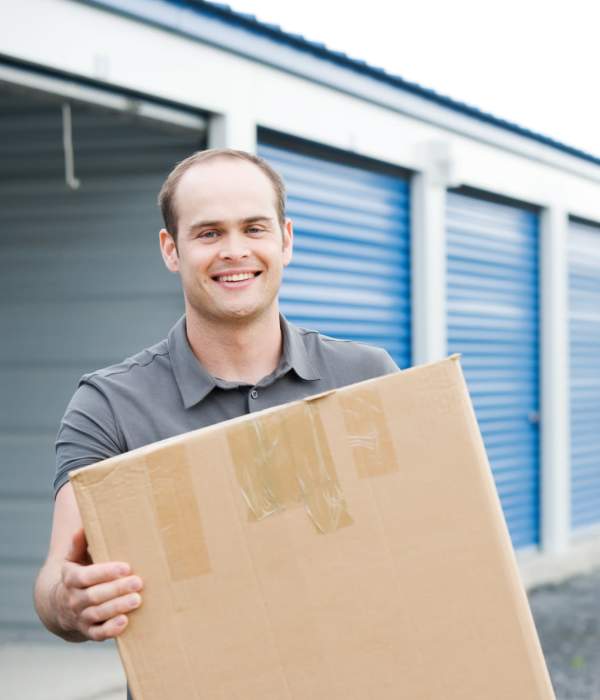 A customer holding a packed box at Storage Hub - Grissom & Tezel in San Antonio, Texas