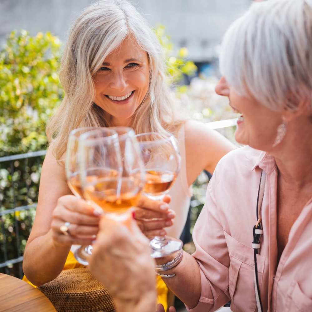 Smiling residents enjoying a drink at their favorite restaurant near Grande Oak Apartments in Williamsburg, Virginia