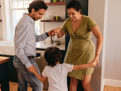 Family dancing in their kitchen at North Main in Walnut Creek, California