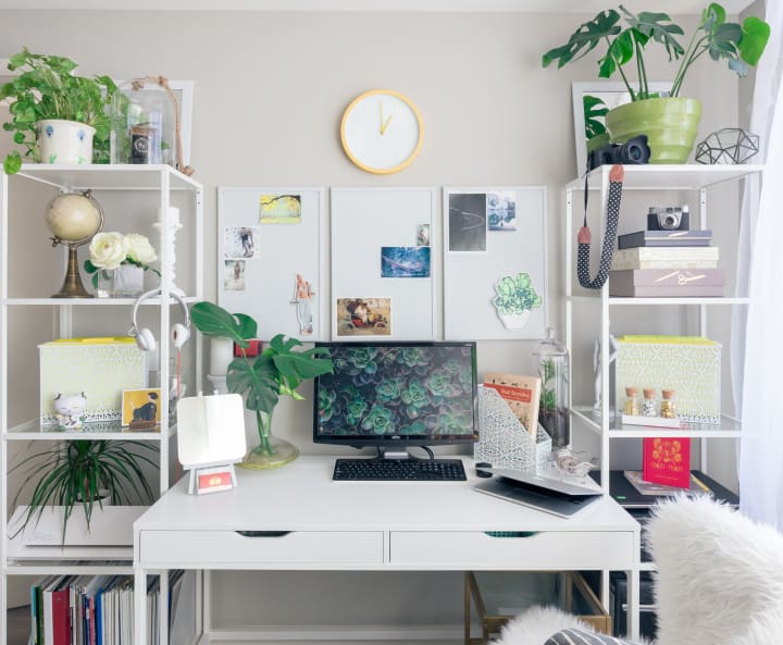 a desk with two shelves on either side for storage space