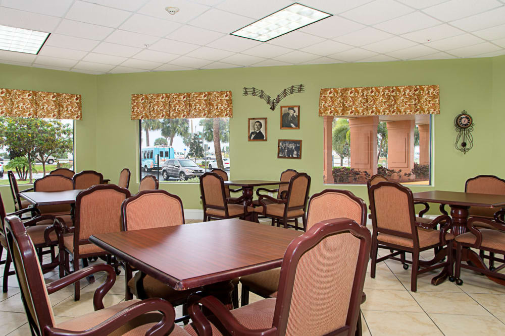 Large dining hall with tables and chairs at Grand Villa of Melbourne in Florida