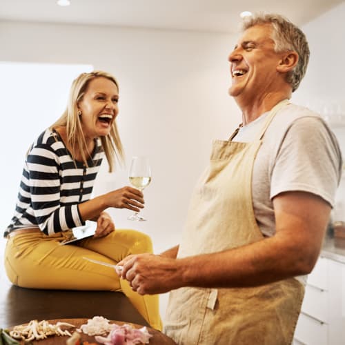 A couple laughing in kitchen at Chollas Heights Historical in San Diego, California