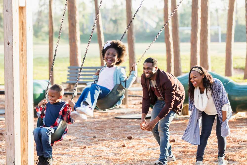 Family playing on the playground at Forest Creek in Oklahoma City, Oklahoma