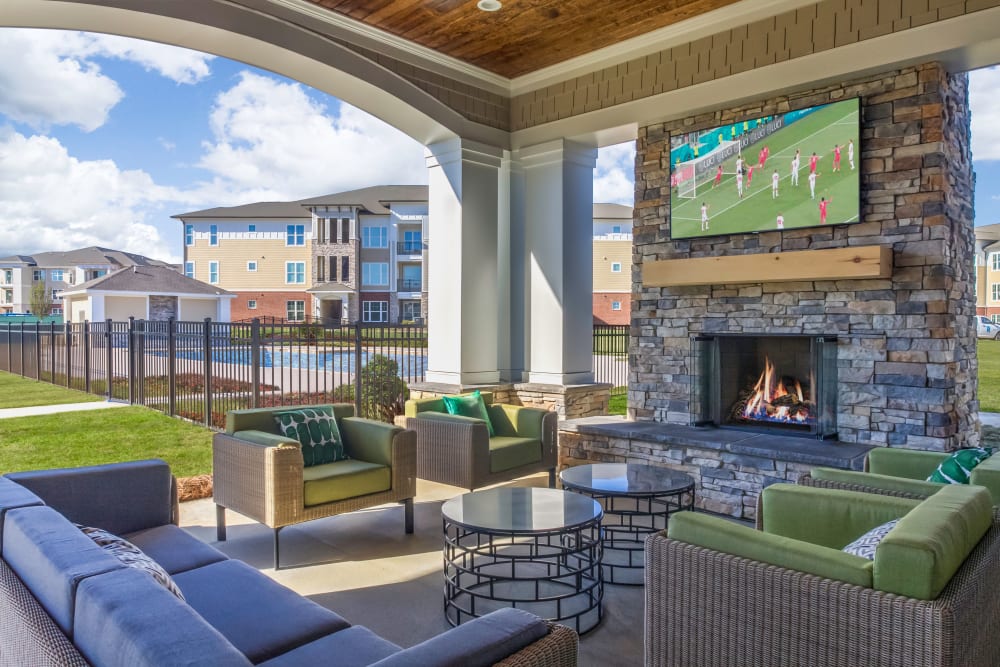 Fire pit surrounded by the resort-style swimming pool at The Palmer in Charlotte, North Carolina