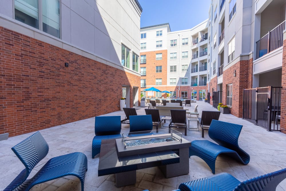 Outdoor fire pit lounge area at The Barton | Apartments in Clayton, MO