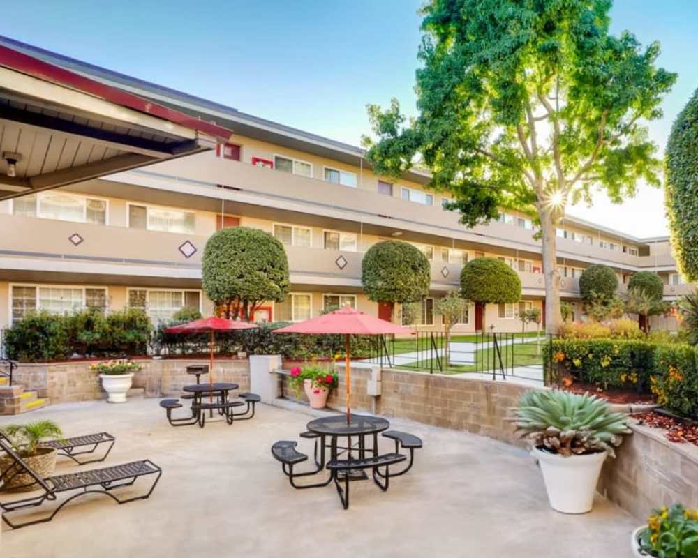 Patio with picnic tables at St. Moritz Garden Apartments in San Leandro, California