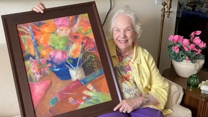 Jan with one of her paintings