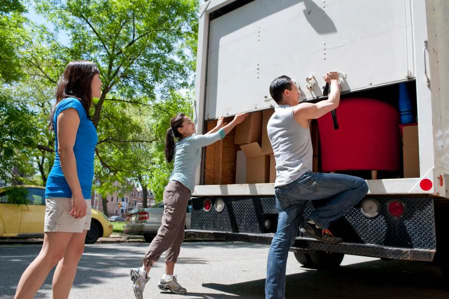 Three individuals loading boxes into a moving truck  at Mountainside Storage in Sultan, Washington