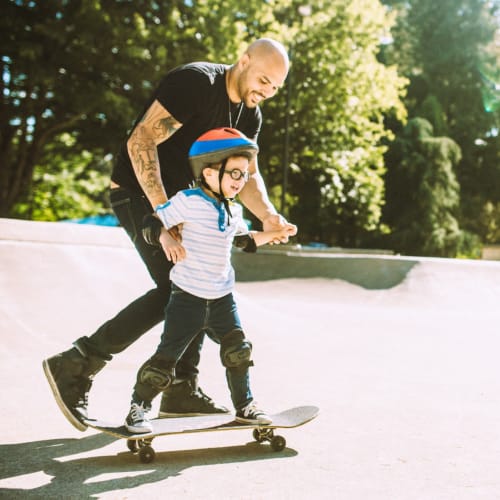 A resident teaching his son to skateboard near Columbia Colony in Patuxent River, Maryland
