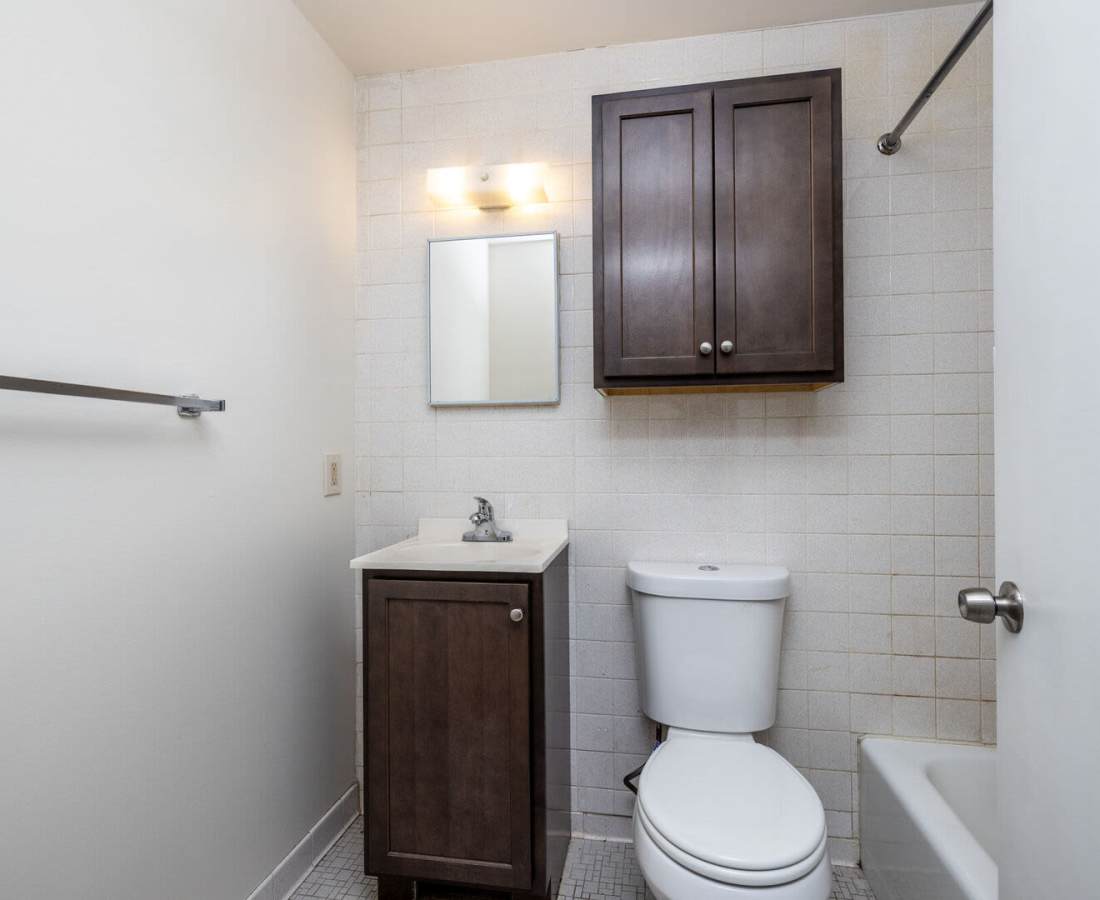 Bathroom with vanity, mirror, and toilet at Eagle Ridge Circle in Rochester, New York