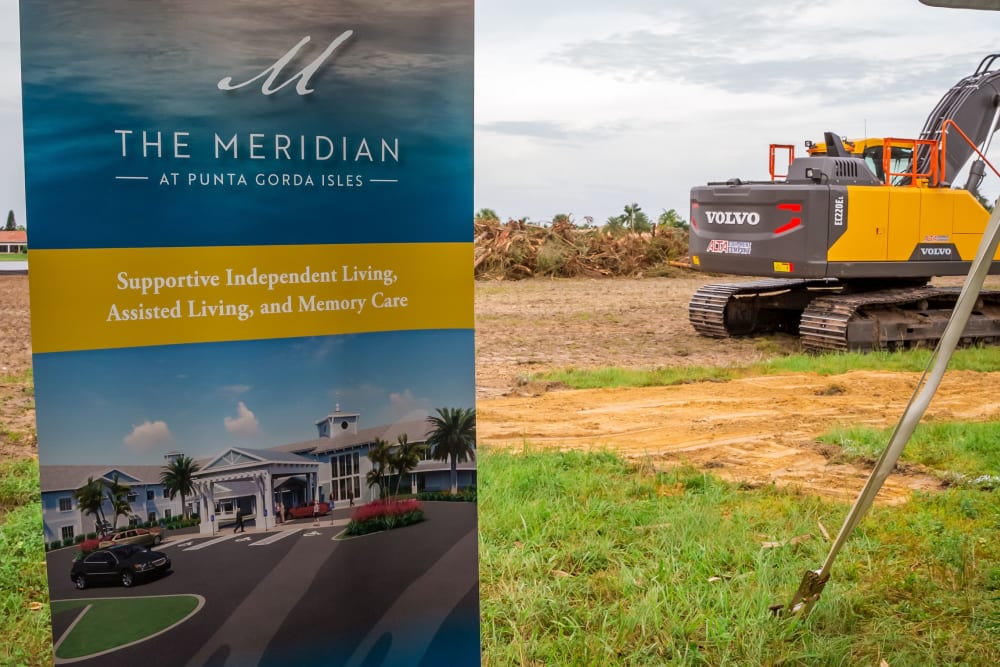 Meridian at Punta Gorda Isles banner in front of tractors