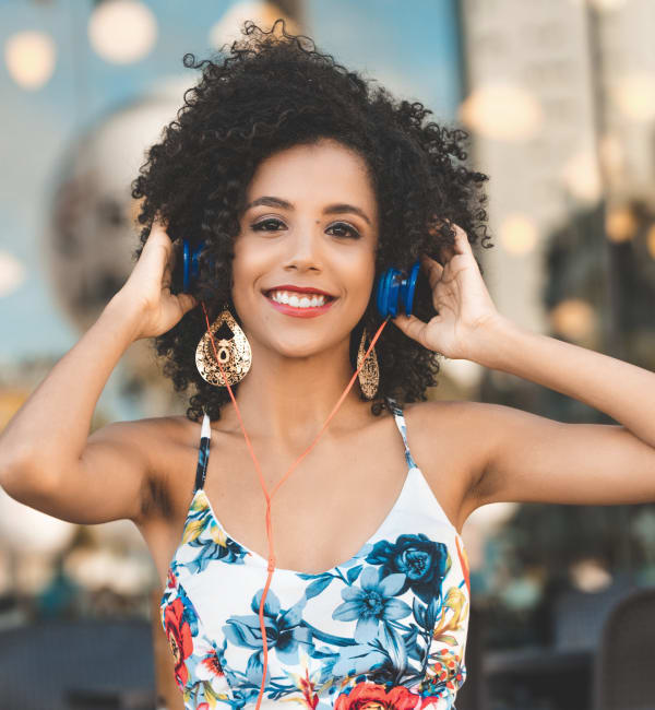 A woman wearing headphones outside near The Alexandria in Madison, Alabama