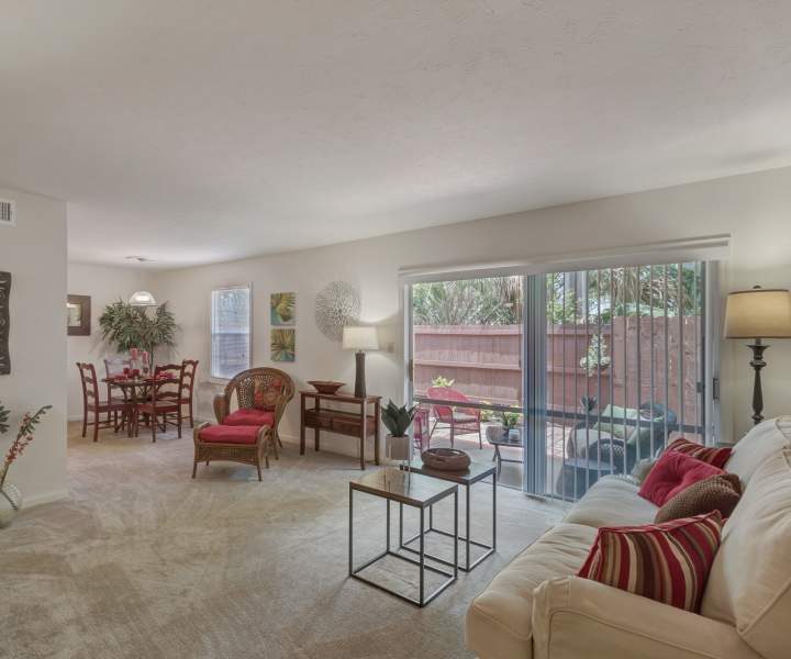 Spacious living room with patio access at Carlton Arms Of Winter Park in Winter Park, Florida 