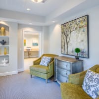 A decorative couch, coffee table and shelf at Evergreens at Mahan in Tallahassee, Florida