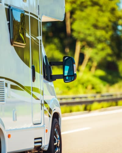 RV driving near a forest near Neighborhood Self Storage